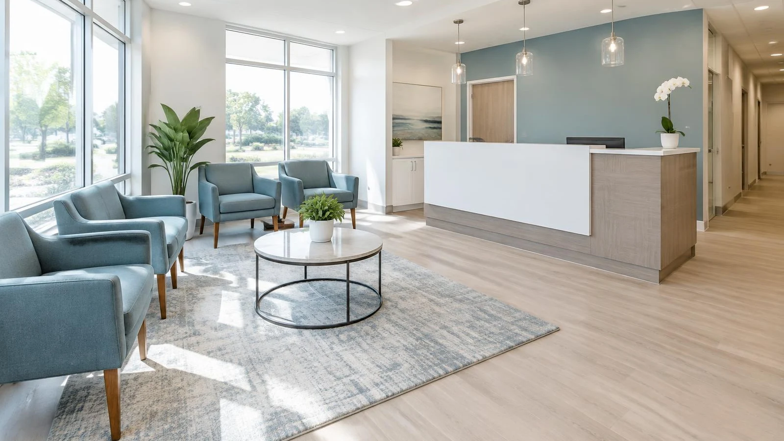 Bright dental office reception area with blue armchairs