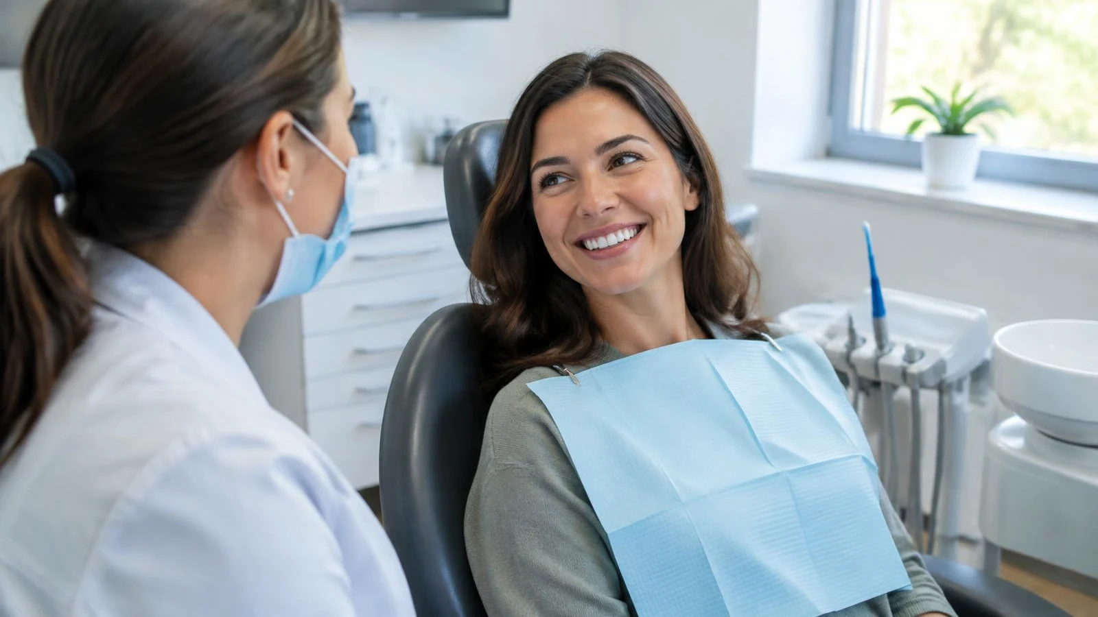 Smiling patient talking with her dentist after an appointment